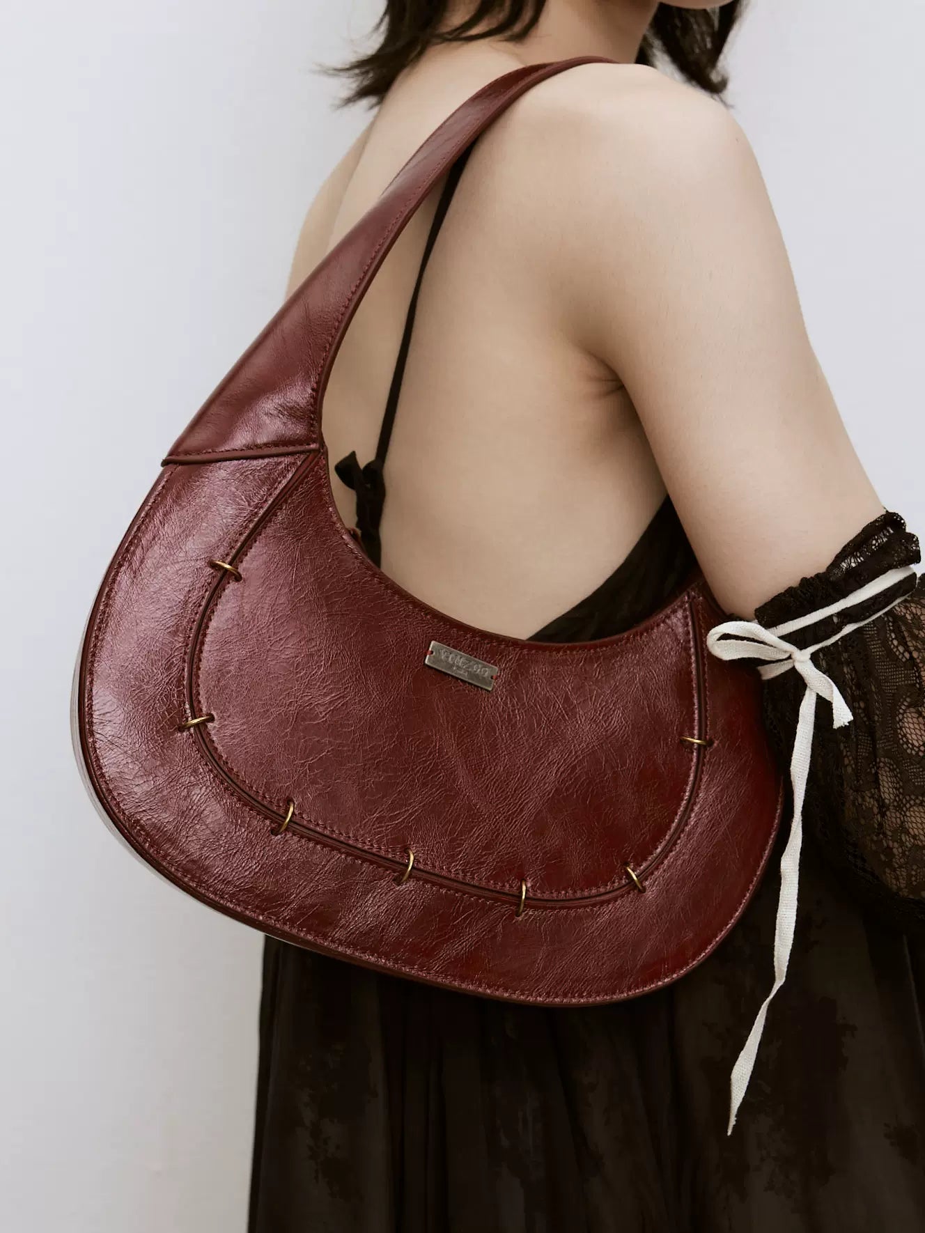 Burgundy leather patchwork shoulder crescent bag